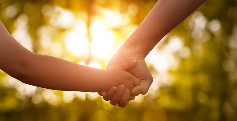 holding-hands An adult holding a child's hand