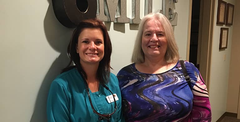 A smiling patient and dentist